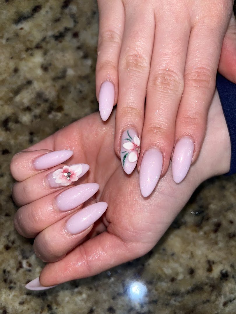 Manicured nails displayed in a salon setting.